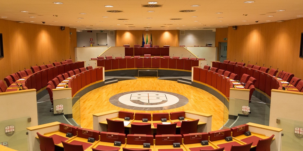 Una stanza vuota con numerose poltrone rosse