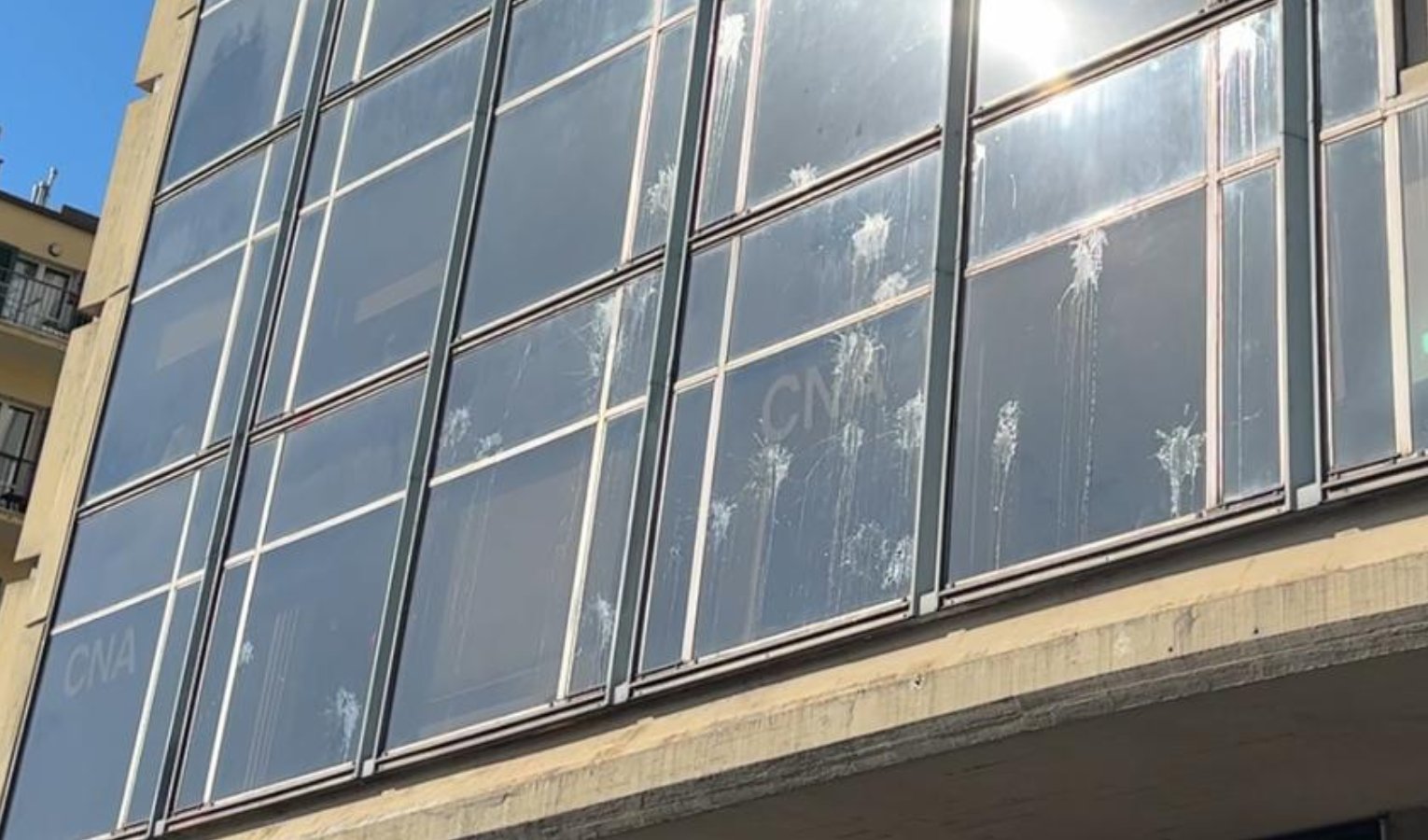 Il segno delle uova lanciate verso le vetrate del palazzo di Confindustria Genova Gruppo di uomini in strada